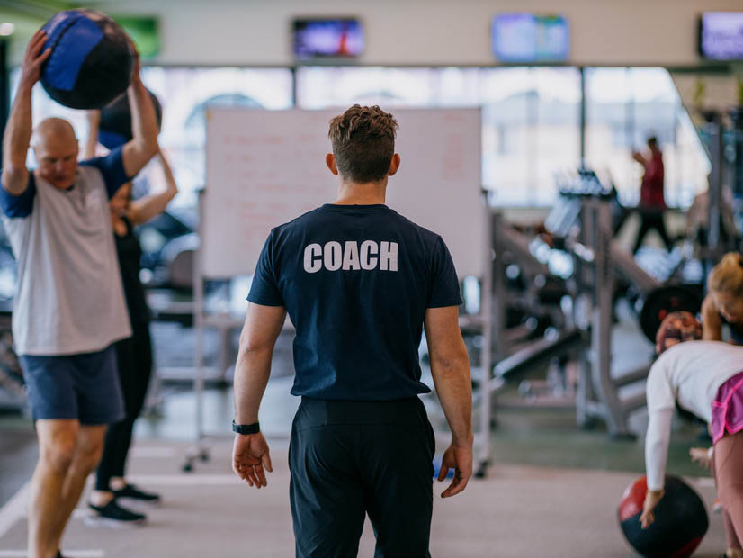 Gym fitness staff supervising people working out at a YMCA gym